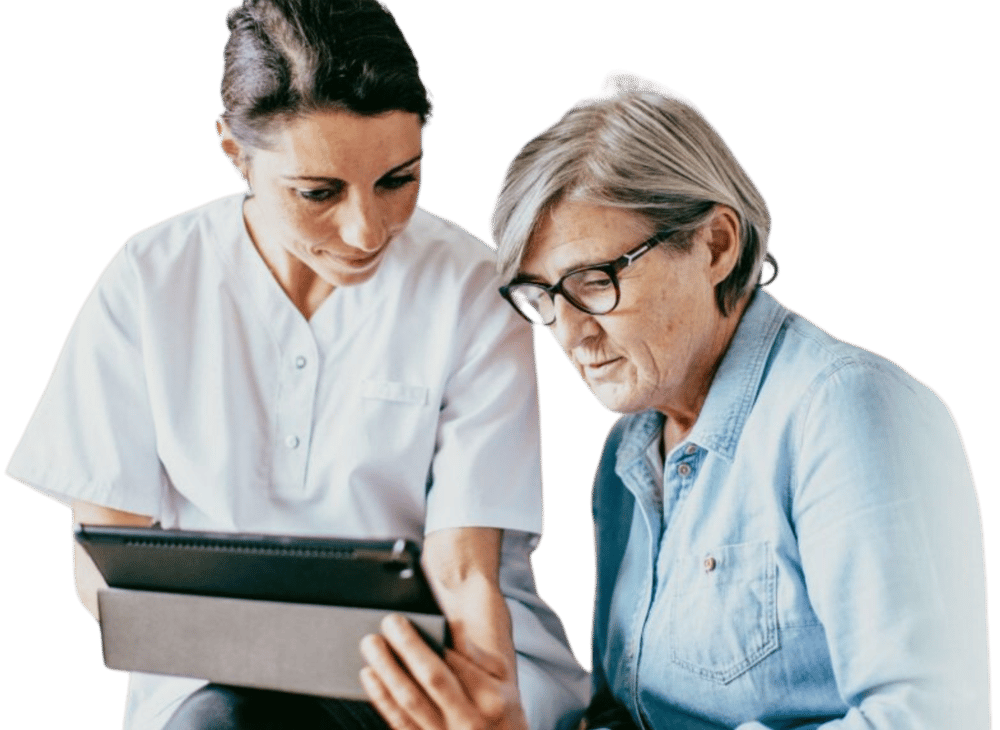 Clinician showing an elderly patient information on a tablet